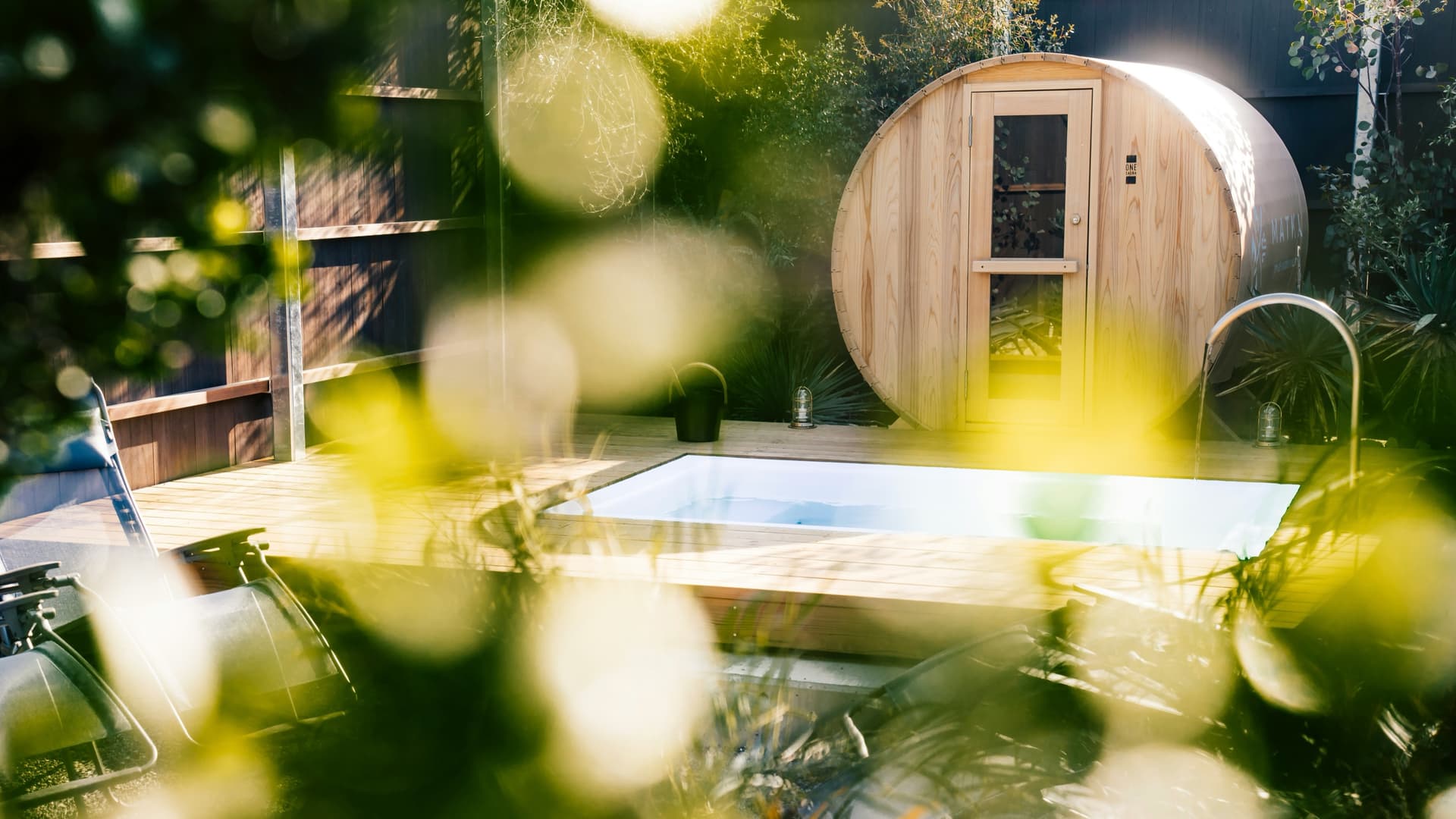 A garden spa and sauna set among lush layered planting