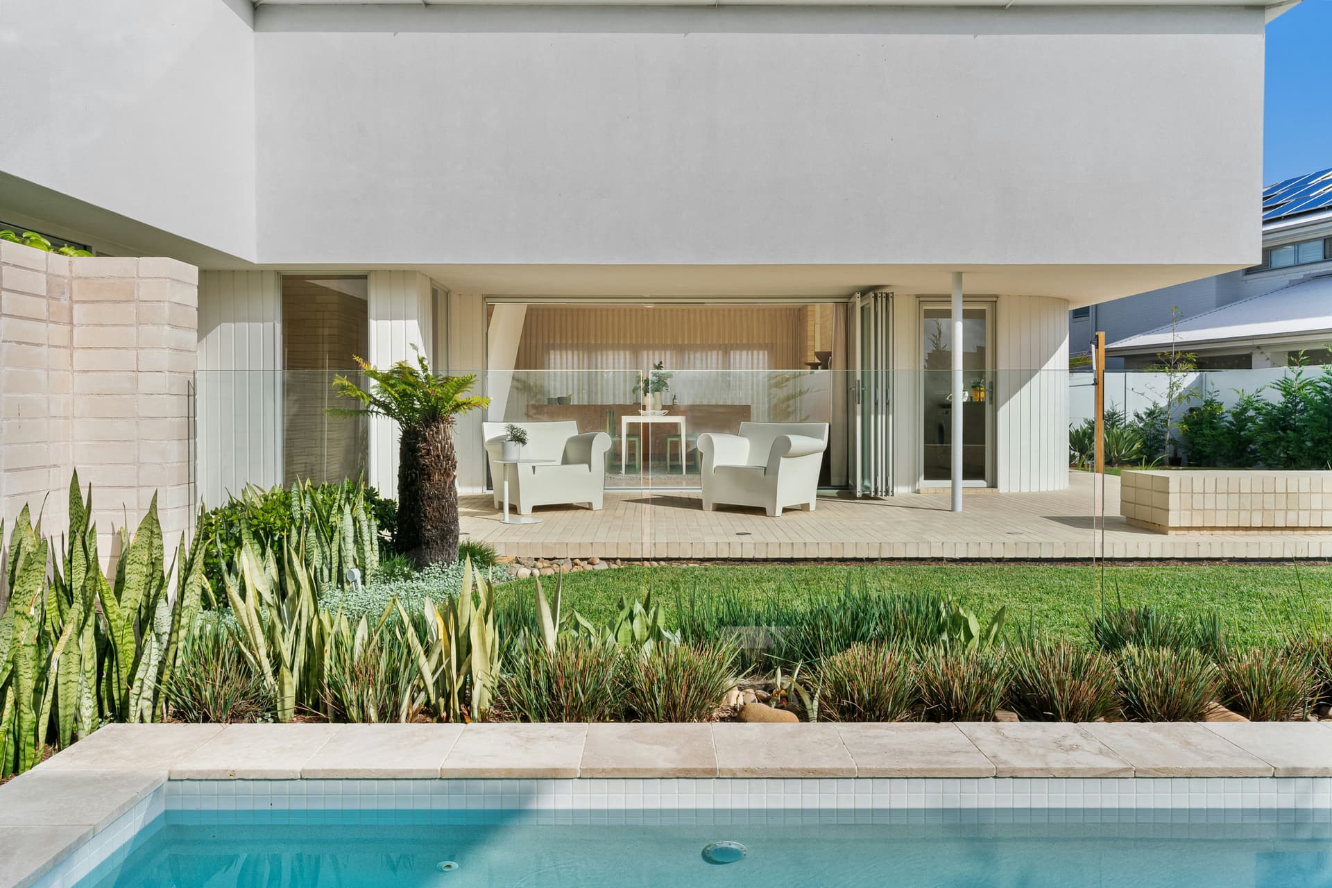 A modern Brisbane home with pool and lush landscape design