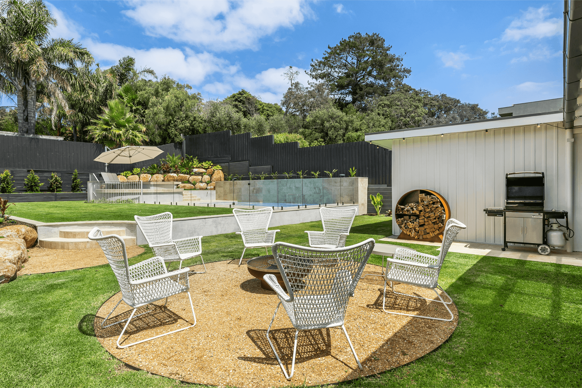 Fire-pit terrace set into layered garden planting